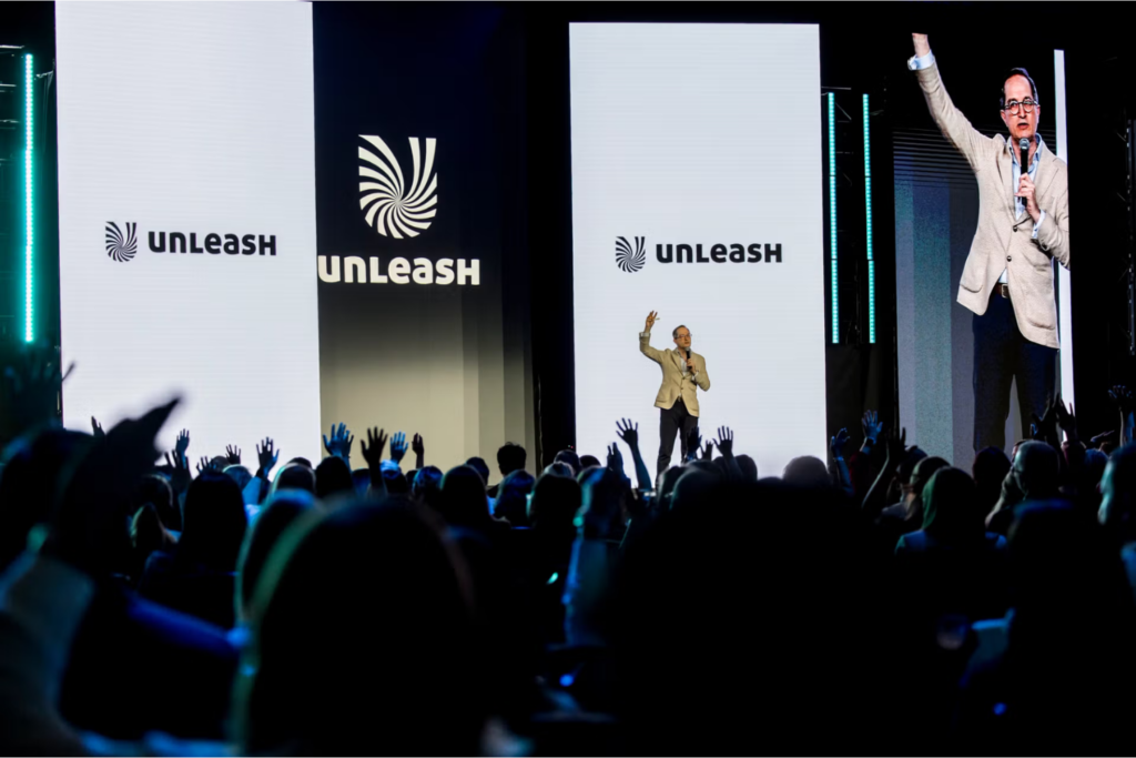 Speaker engaging a large audience at the UNLEASH World conference